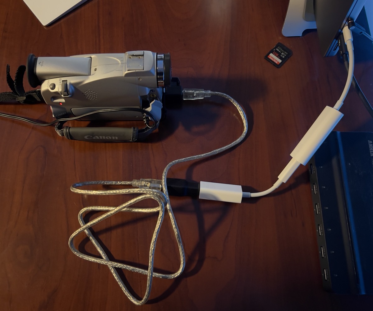 Camera with many adapters plugged into MacBook Pro
